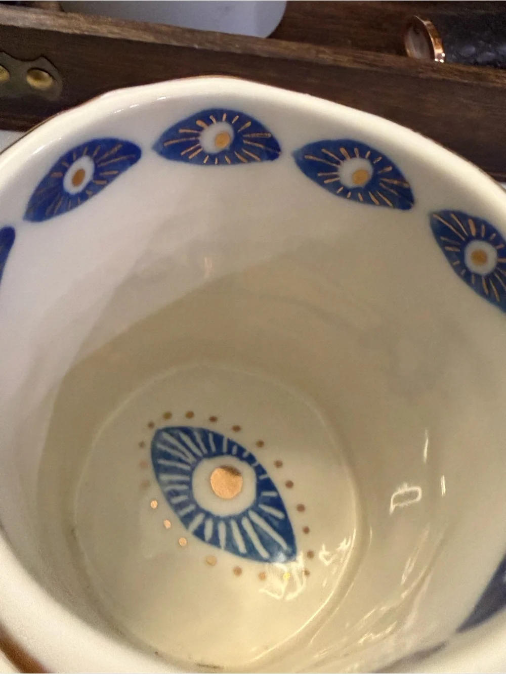 Anthropologie White Ceramic Mug with Blue Eye Motif and Gold Trim